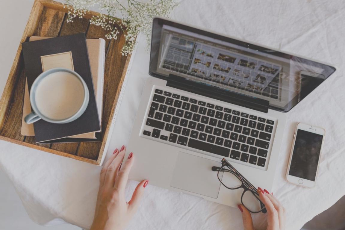 Person reviewing financial documents and expense tracking sheets